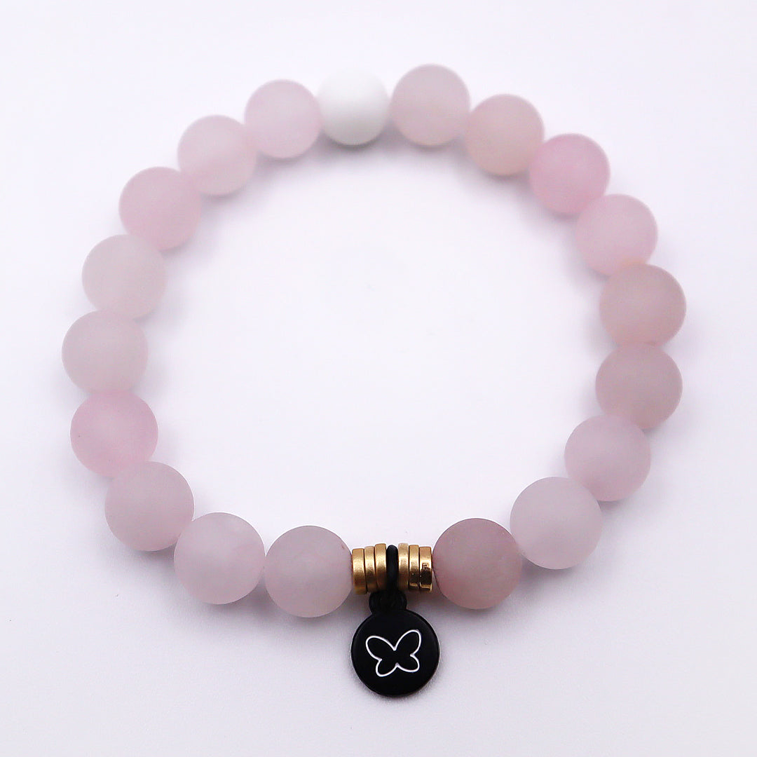 pink bracelet with gold accent beads and butterfly charm