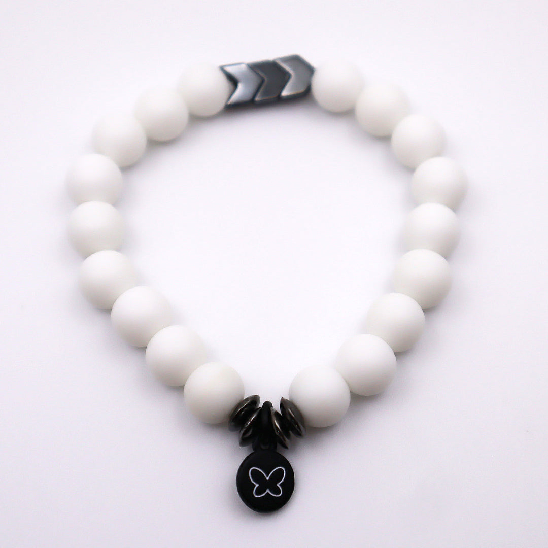 white beaded bracelet with gun metal accent beads and butterfly charm