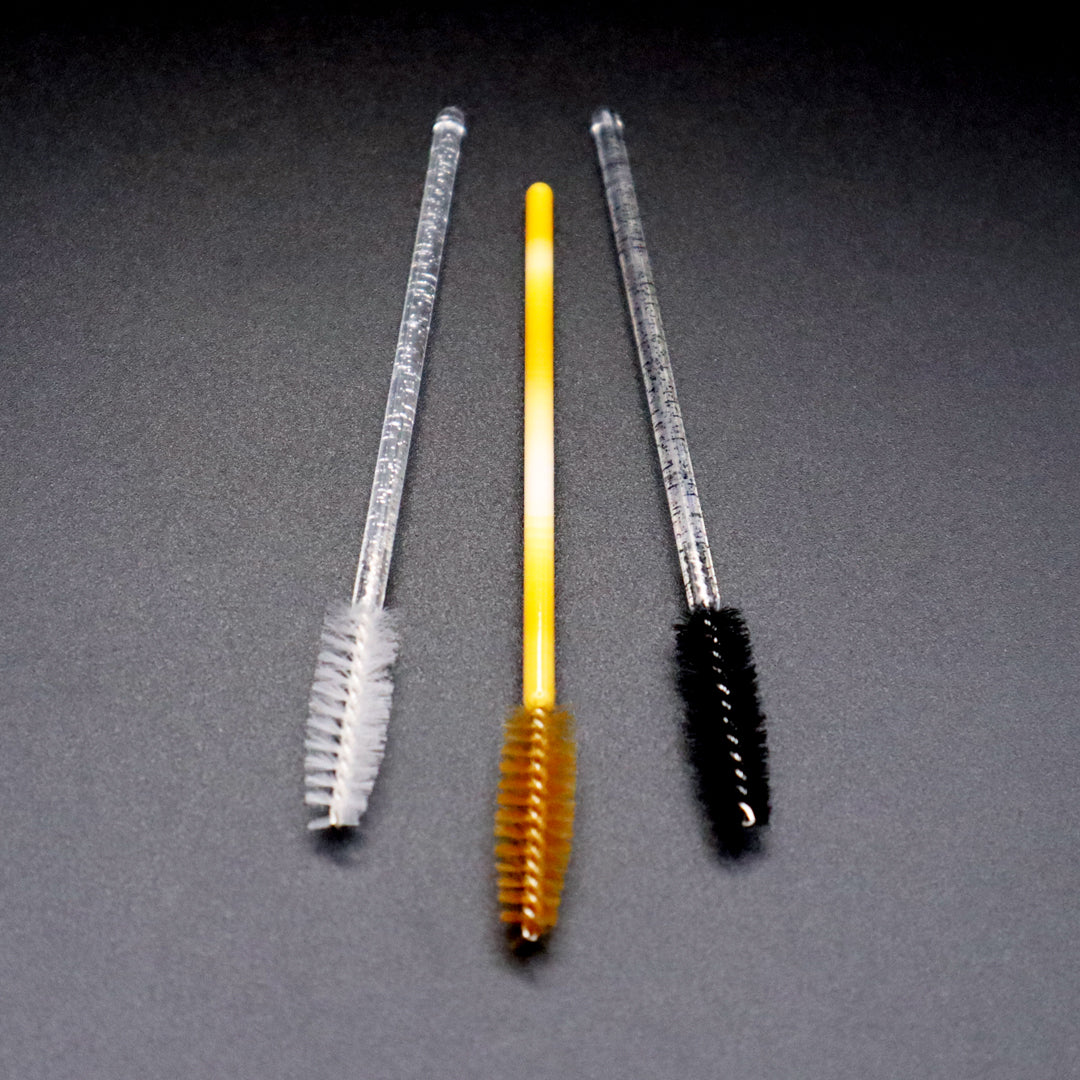 white, gold, and black mascara wands