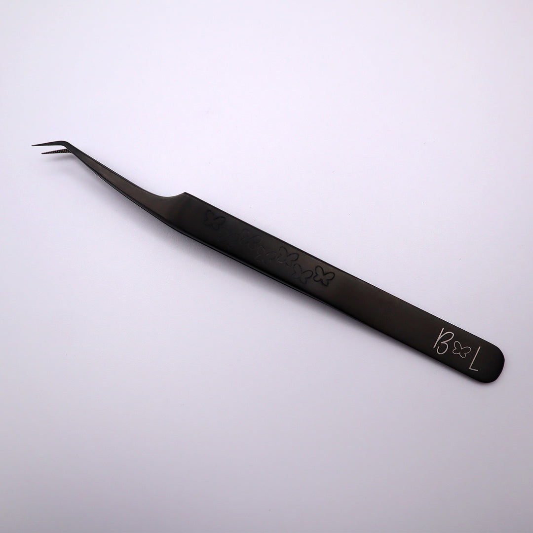black slanted fiber tip tweezer with hand grip on front