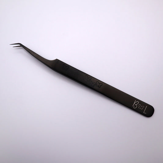 black slanted fiber tip tweezer with hand grip on front