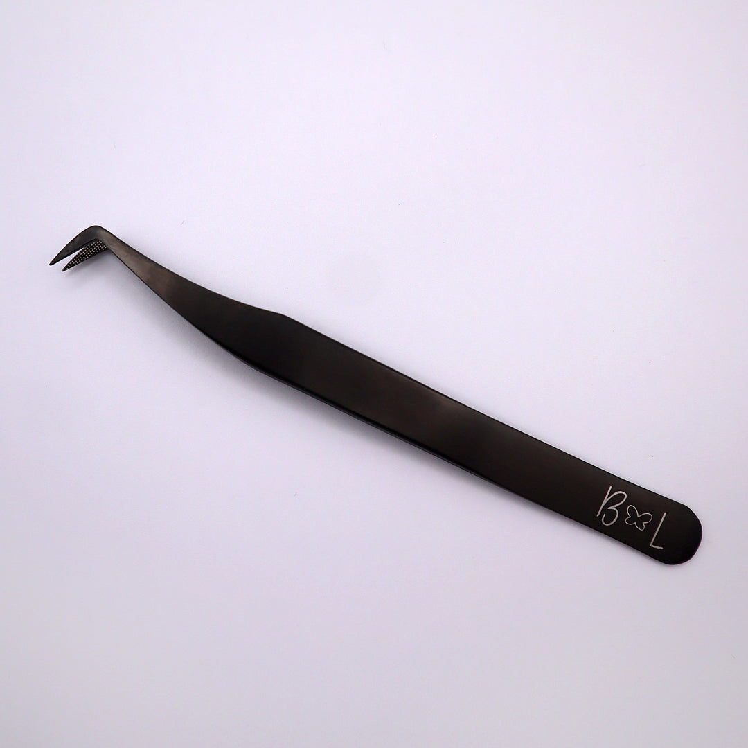 black boot shaped tweezer with butterfly logo